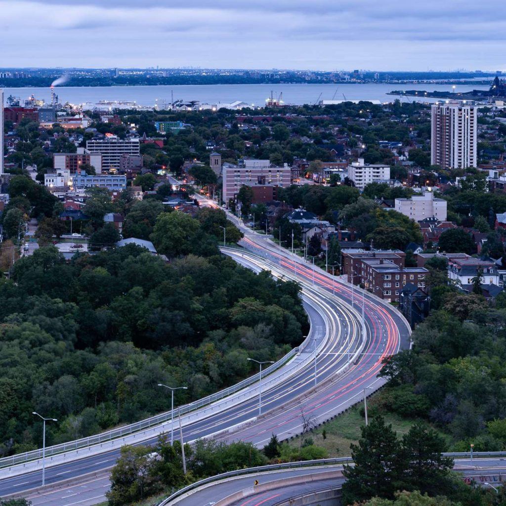 an aerial view of a city with a highway going through it